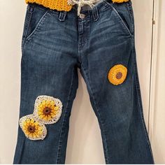 a pair of jeans with crocheted flowers on them