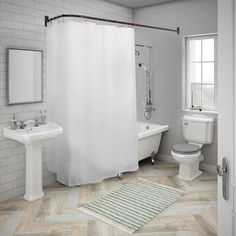 a bathroom with a shower, sink, toilet and bathtub is shown in this image