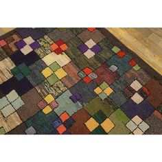 a multicolored patchwork rug is laying on the floor