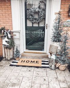 a front door decorated for christmas with wreaths and decorations