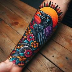 a person with a colorful tattoo on their arm and leg, holding a bird in front of