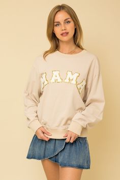 Feel the comfort and style of the Mama Sequin Varsity Letter Sweatshirt! Featuring an ultra-soft and cozy taupe sweatshirt embellished with stunning white chinelle sequin letters, this piece is perfect for the cool days of fall! Look and feel your... Varsity Letter Sweatshirt, Varsity Letters, Letter Sweatshirt, Embellished Sweatshirts, Varsity Letter, The Perfect Girl, Mama Sweatshirt, Graphic Tops, Some Girls