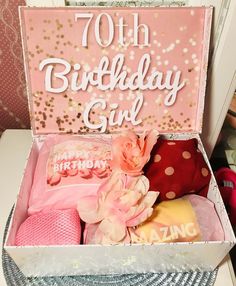 a birthday gift box with pink and gold decorations