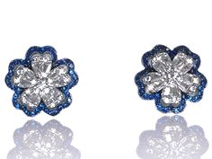 These exquisite 925 sterling silver flower earrings showcase a charming floral design adorned with dazzling white and blue cubic zirconia stones. Each petal is meticulously crafted from high-quality sterling silver, providing a lustrous sparkle and finish. The center of each flower sparkles with a brilliantly cut cubic zirconia, adding a touch of elegance and sophistication. Perfect for both everyday wear and special occasions, these earrings feature secure butterfly backs for a comfortable fit. Blue Flower-shaped Diamond Jewelry, White Cubic Zirconia Flower Earrings With Brilliant Cut, White Brilliant Cut Cubic Zirconia Flower Earrings, Blue Sterling Silver Earrings With Pave Setting, Silver Diamond Flower Earrings, Diamond White Cubic Zirconia Flower Earrings, Sterling Silver Flower Earrings In Diamond White, White Gold Cubic Zirconia Flower Earrings, Blue Flower Earrings For Formal Occasions