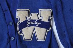 Very cool authentic varsity sweater! Classic blue colour, with large chenille embroidered patch on the front left "W" with "Judy" across the front, and another chenille embroidered patch number "66" on the sleeve. The tag on the back neck writes "AWARD SWEATER, Em-Rose Sporting Goods Co., Indianapolis". Also chain-stitched on the bottom inside left is "J Wethington". Very well made piece, patches are excellently made. This is marked a US Women's size 38 - fits approximately like a small/medium. Letterman Sweaters, Jumper Designs, Vintage Varsity, Varsity Sweater, Blue Colour, Embroidered Patch, Chain Stitch, School Days, Classic Blue