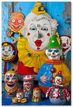 an assortment of clowns on display in front of a blue door