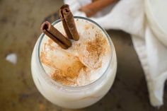 a drink with cinnamon sticks sticking out of it