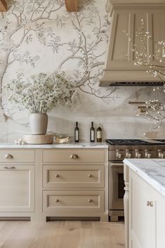 a kitchen with an oven, stove and wallpaper in the back drop off area