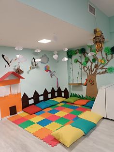 a child's play room with colorful carpets and toys on the floor, including a tree