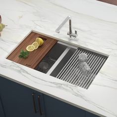 a kitchen sink with a cutting board and lemons on the counter next to it