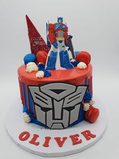 a birthday cake decorated with an image of a robot and the words, oliverr