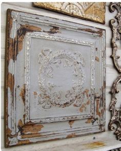 an old white frame is hanging on the wall