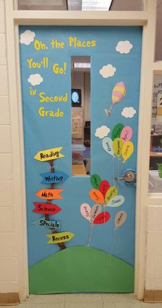 a classroom door decorated with balloons and writing on the front, which reads oh the places you'll go in second grade