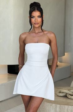 You've got the occasion, we've got the outfits. Fleur is our new flirty mini, cut from our luxe crepe with a stretch for added comfort. This chic strapless design is fitted through the bust and waist, flaring gently at the hip into an A-line skirt. Wear yours with simple muled heels and minimal jewellery. 



Colour: Ivory.

Premium stretch crepe.

Fully lined.

Strapless neckline.

Fitted through the bust and waist.

Ruched detailing to waist.

Flares at hip.

A-line skirt.

Invisible zipper fa Mini Dresses Summer Party, Mini White Dress Classy, Preppy Graduation Dress, Black Mini Birthday Dress, Classy Simple Dress, White Graduation Dress College Classy, White College Graduation Dress, Classy Graduation Outfit, Classy Graduation Dress