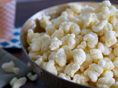 a bowl filled with popcorn sitting on top of a table