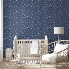 a baby's room decorated in blue and white with stars on the wall