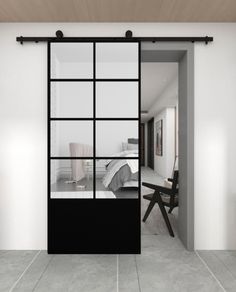 an open door leading to a bedroom with white walls