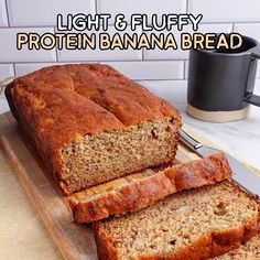 two slices of banana bread on a cutting board with the words light and fluffy protein banana bread