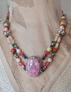 Welcome to my store. Please check all dimensions given. This necklace has a combination of soft and subtle beads reflecting many of the colors in the center piece. there are two strand from the bloodstone graduating to a single strand. There are Tourmalines, Rhodonite, Calcite, Aventurine as well as European beads. A very pretty necklace and One of a Kind. Handmade Double Strand Agate Beaded Necklace, Handmade Multi-strand Agate Beaded Necklaces, Pretty Necklace, Beaded Pendant Necklace, Pretty Jewelry, Pretty Necklaces, Lovely Necklace, Pretty Jewellery, Beaded Pendant