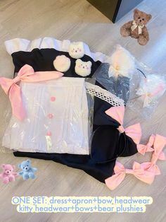 there are many items on the floor and one is pink, white, and black