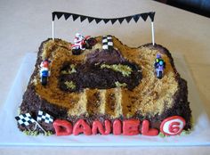 a birthday cake with cars and race flags on it