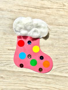 a paper stocking made to look like a shoe with buttons on the bottom and a cloud above it