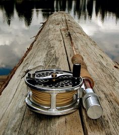 a fishing rod and reel on a wooden dock