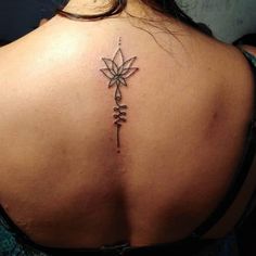 a woman's back with a tattoo on it