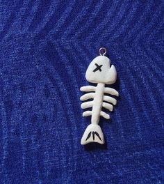 a ceramic skeleton ornament on a blue background