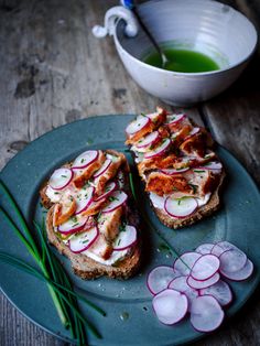 two pieces of bread on a plate with radishes