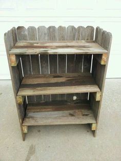 a wooden shelf sitting on top of a cement floor