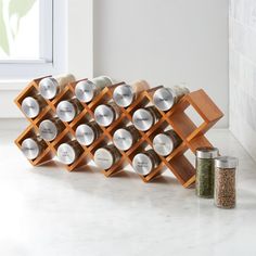 the spice rack is made out of wood and holds spices