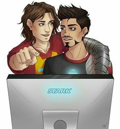 two people standing in front of a computer screen with the word stark on it and pointing