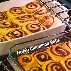 two pans filled with cinnamon rolls sitting on top of an oven