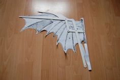 a paper model of a dragon on a wooden floor