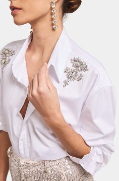 Mitchie Crystal Poplin Shirt Embrace stunning style with the Mitchie Crystal Poplin Shirt from Generation Love. Crafted from high-quality poplin, this shirt features delicate crystal accents that add a touch of elegance to its timeless design. The classy button-down style makes it perfect for any occasion, from casual gatherings to formal events. High-quality poplin fabric Delicate crystal accents Timeless button-down design Versatile for any occasion With the Mitchie Crystal Poplin Shirt, you'l Embellished White Shirt, White Poplin Shirt, Embellished Shirt, Church Outfit, Rhinestone Top, Stunning Style, Denim Outerwear, 4th Of July Outfits, Sequin Mini Skirts