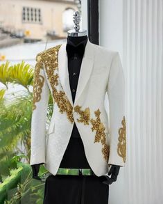 Make a statement in this Bespoke exquisitely crafted white tuxedo jacket. This jacket is perfect for any special occasion, from a wedding to a black-tie gala. It features a classic, tailored fit with a sleek, modern silhouette. The jacket is crafted from high-quality, luxurious fabric and is adorned with intricate golden beading and gems details. The jacket is fully lined and has a single button closure. The jacket comes with a matching pocket square and is a must-have for any man's wardrobe. Cu Luxury Men's Tuxedo With Lapel Collar, Luxury Gentleman's Tuxedo With Ties, Luxury Gentleman Tuxedo With Ties, Luxury Brocade Men's Tuxedo, Luxury Men's Tuxedo Dress Shirt, Luxury Men's Tuxedo For Party, Luxury Men's Suit For Costume Party, Mens Black And Gold Tuxedo Jacket, Luxury Cream Tuxedo For Semi-formal Events