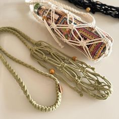 three different types of rope on a white counter top next to an object that looks like a roll of string