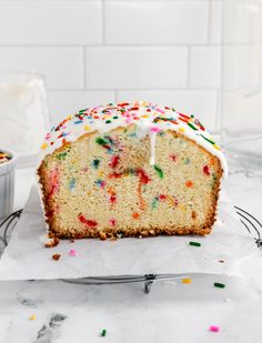 a cake with white frosting and sprinkles on it