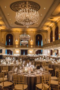 an elegant ballroom with chandeliers and tables