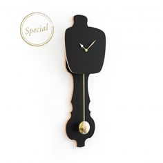 a black clock with gold hands on a white wall next to a special stamp that says special