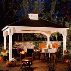 a white gazebo sitting on top of a lush green field