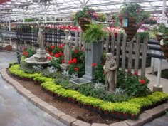 a garden center with flowers and statues in it