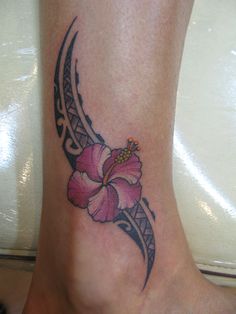 a foot with a flower tattoo on it