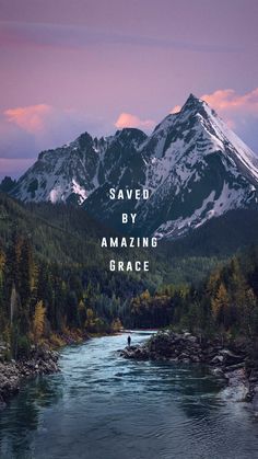 a man standing on the edge of a river in front of mountains with words saying saved by amazing grace