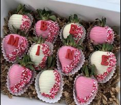 a box filled with chocolate covered strawberries in the shape of heart shaped letters and hearts