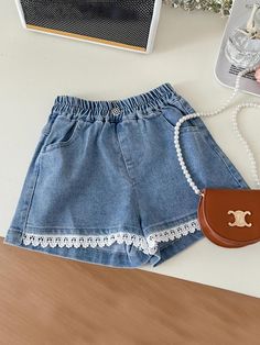 A white top and denim short set that will make your little doll extra adorable all day? It's a YES for us! Ruffle details on top and lace hem on the bottom for the freshest springtime look. Soft, lightweight fabric that gives her cool-girl confidence all day. Pre-styled with pieces that work all year round. Easy to mix and match with her other faves. Perfect for spring, casual outings, fashion photoshoots, and year-round style adventures Set includes white ruffled top and denim shorts with lace hem and elastic waist Available in sizes 4T-10Y for toddlers and little girls Cute Lace Trim Bottoms For Spring, Cute Denim Blue Cotton Shorts, Spring School Shorts, Cute White Cotton Jean Shorts, Cute Cotton Jean Shorts, Spring Cotton Shorts With Lace Trim, Casual Cotton Shorts With Crochet Trim, Cute Spring Shorts For School, Cute Shorts For School In Spring