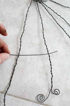 someone is working with wire to make a piece of art