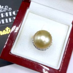 A lustrous pearl, cocktail ring is a need for every lady in the world. What could get you more attention than having this huge, exotic, and sparkling pearl ring on your finger while holding a glass of wine? We are presenting you with a Huge GOLDEN SOUTH SEA PEARL, absolutely natural color and TOP AA+ luster, 14 mm in size, surrounded by 22 pieces of hand-set F/VS superb quality diamonds, weighting at 0.64 carat. Set in handcrafted, one of a kind 18K solid white gold ring, weighting at 8.0 grams. Luxury Pearl Diamond Ring As Gift, Elegant Silver Pearl Ring For Party, Elegant Pearl Ring For Party, Diamond Pearl Ring With High Luster For Gift, Gift Pearl Ring With High Luster And Diamond, Elegant Pear-shaped Diamond Ring Gift, Golden South Sea Pearls, Sea Pearl, South Seas