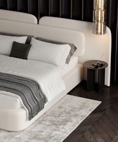 a large bed with white sheets and pillows on top of it next to a night stand